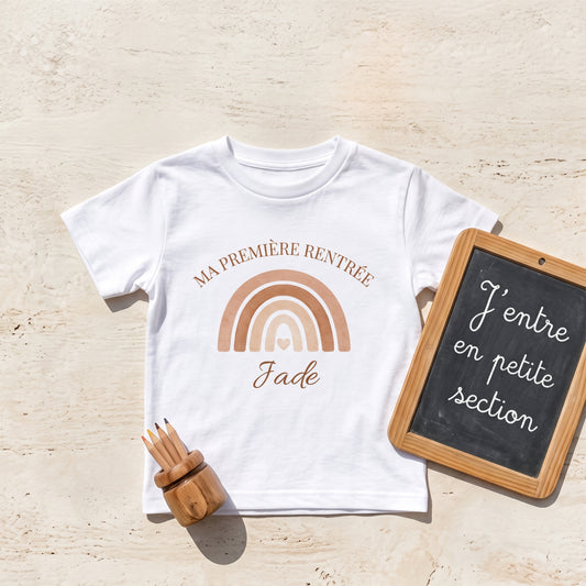 T-shirt personnalisé rentrée scolaire posé avec ardoise J'entre en petite section, crayons et arc-en-ciel terracotta