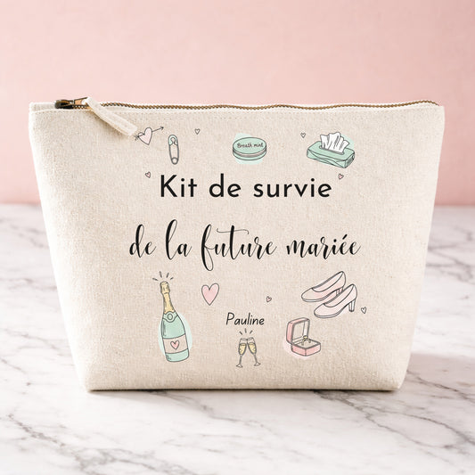 Trousse personnalisée en coton pour future mariée, prénom Pauline, inscription « Kit de survie de la future mariée » avec illustrations doodles (champagne, escarpins, bague).