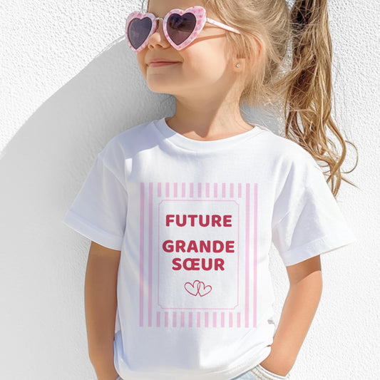 T-shirt enfant blanc future grande sœur, cadre rose poudré à rayures avec deux cœurs entrelacés